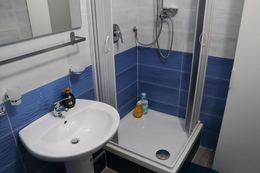 un piccolo bagno con lavandino e doccia di B&B Francesco Fly a Napoli