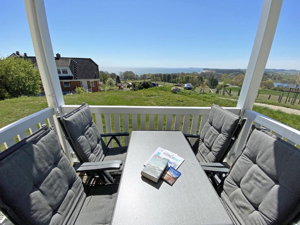 a table and chairs on a porch with a view at Haus Greifswalder Bodden - FeWo 06 in Göhren