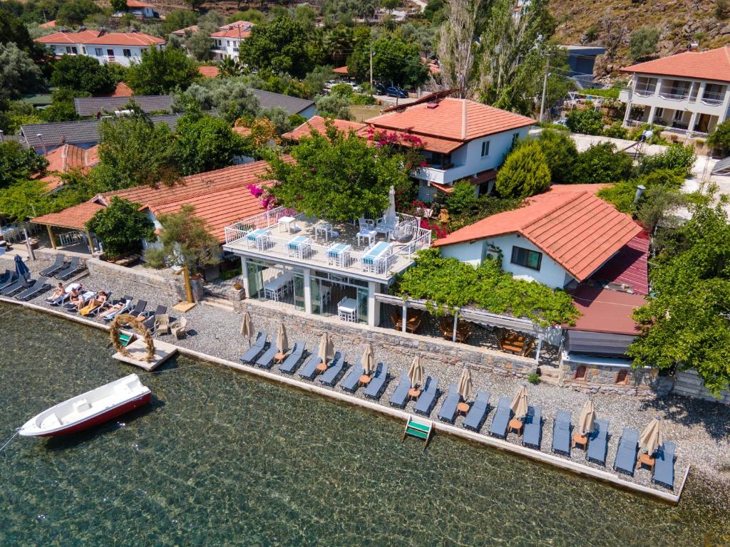an aerial view of a house with a boat in the water at BÜŞRA SELİMİYE in Marmaris