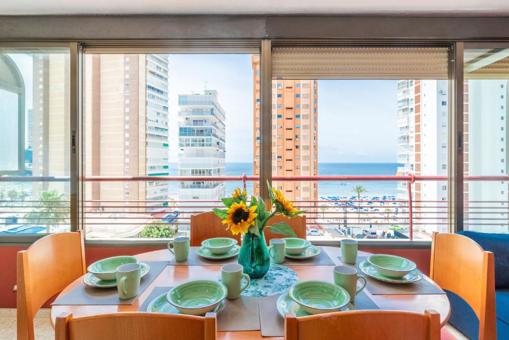 a dining room table with a view of the ocean at Coblanca 7 in Benidorm