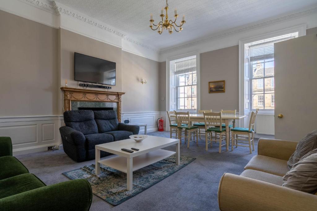 a living room with a couch and a table at Luxury Apartment/Flat Edinburgh City Centre in Edinburgh