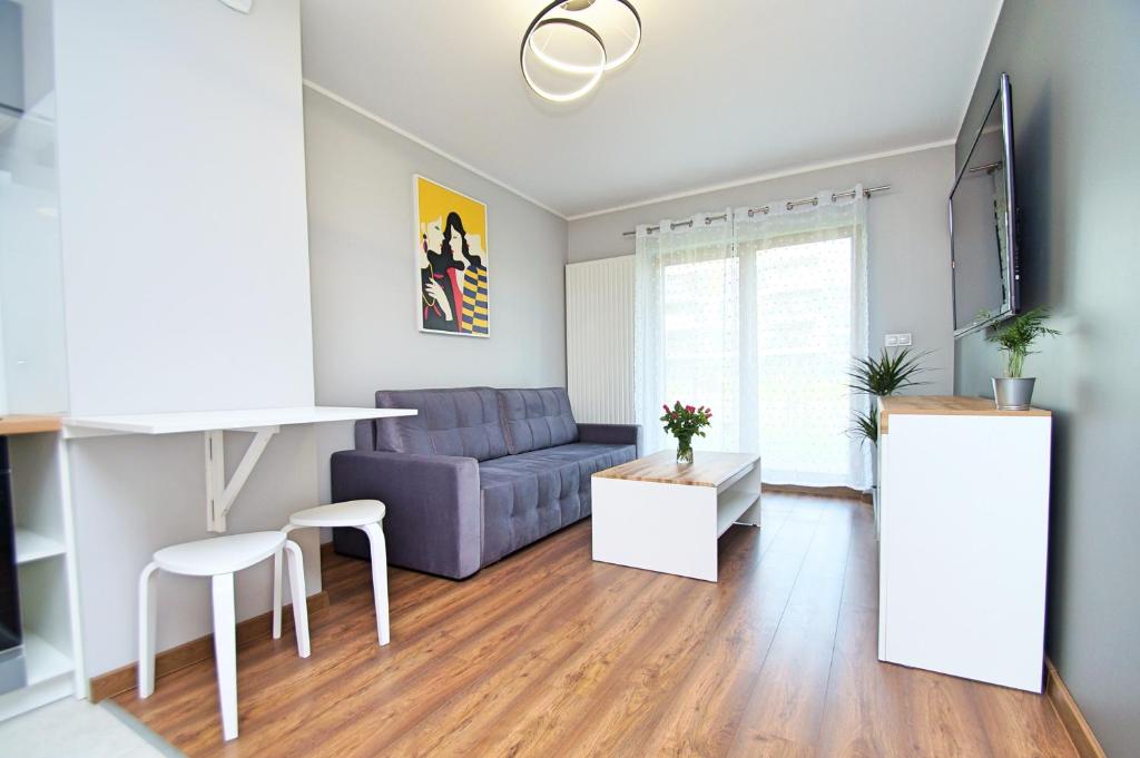 a living room with a couch and a table at Apartament Katowice Meteorologów in Katowice