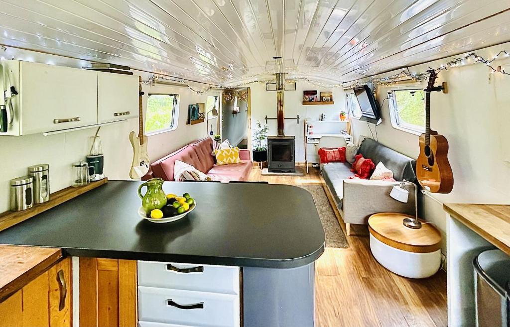 a kitchen and living room in an rv at Boutique Boat Stays Contemporary Barge in Bath