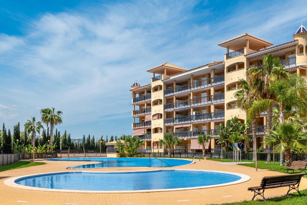 a resort with a swimming pool and a building at Lopimar Guillen de Castro in Canet de Berenguer