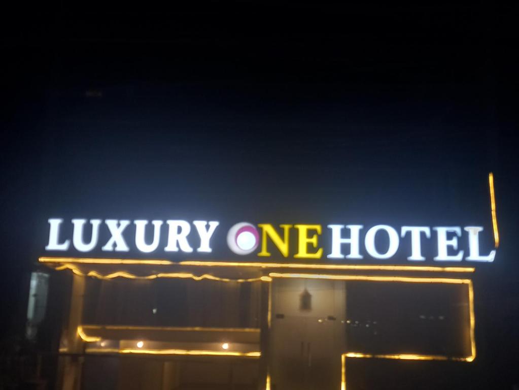 a neon sign for a luxury one hotel at night at Luxury one hotel Lahore in Lahore
