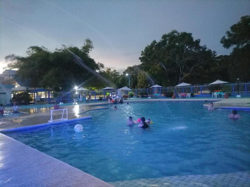 a group of people in a swimming pool at night at Hotel campestre la Maria in Villavicencio