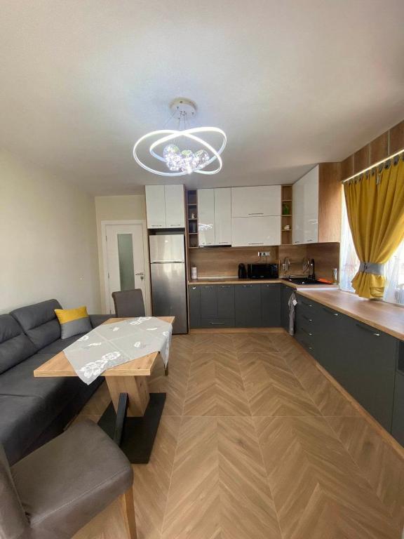 a living room with a couch and a table and a kitchen at Apartment Veronika in Sozopol