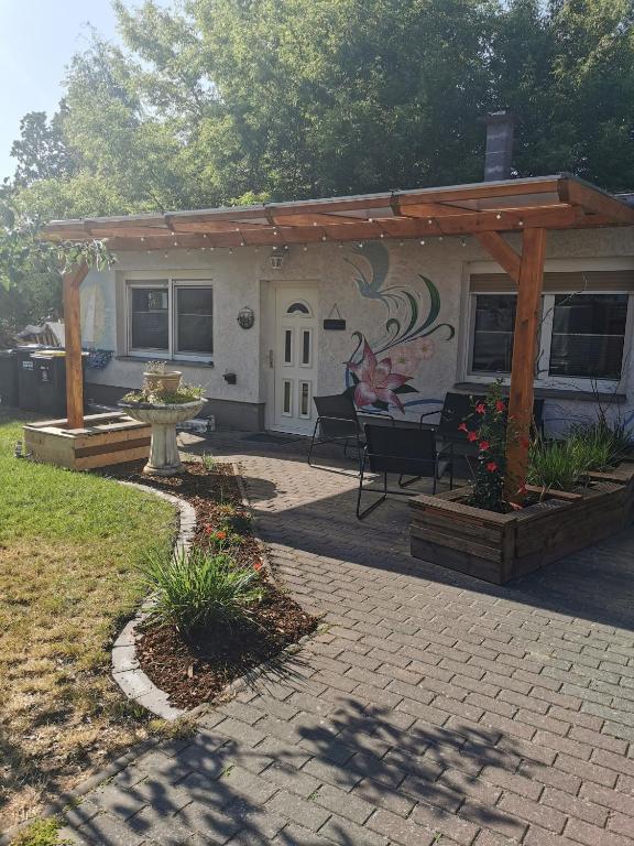 a patio with a pavilion and a fountain in a yard at Casa Auszeit in Oranienburg