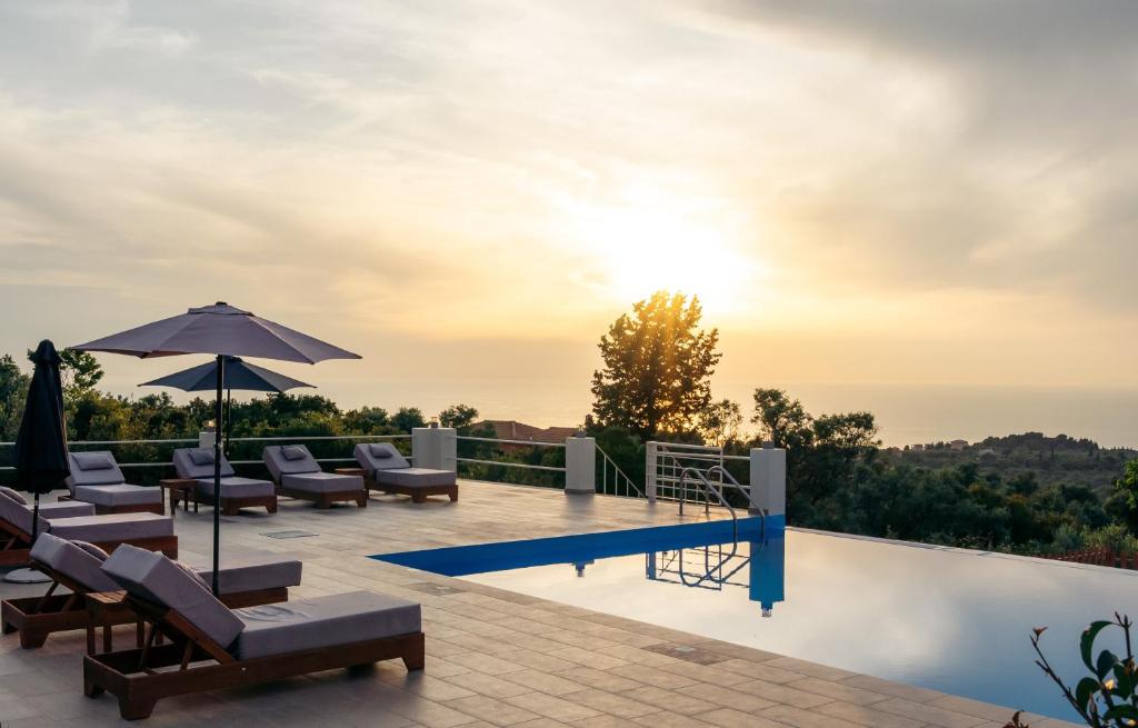 a villa with a swimming pool and a sunset at Villa Erato in Tsoukaladhes
