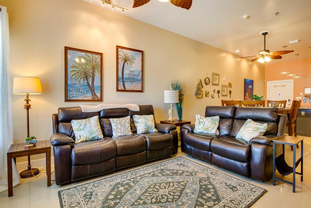 a living room with two leather couches and a rug at South Padre Island Vacation Rental with Pool Access! in South Padre Island