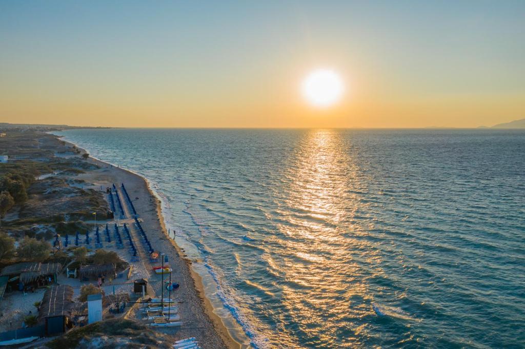 an aerial view of a beach at sunset at Anthia Apartments in Marmari