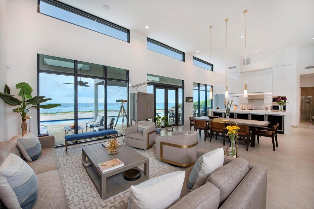 a living room with a couch and a table at Wind Upon The Waves by Grand Cayman Villas & Condos in North Side