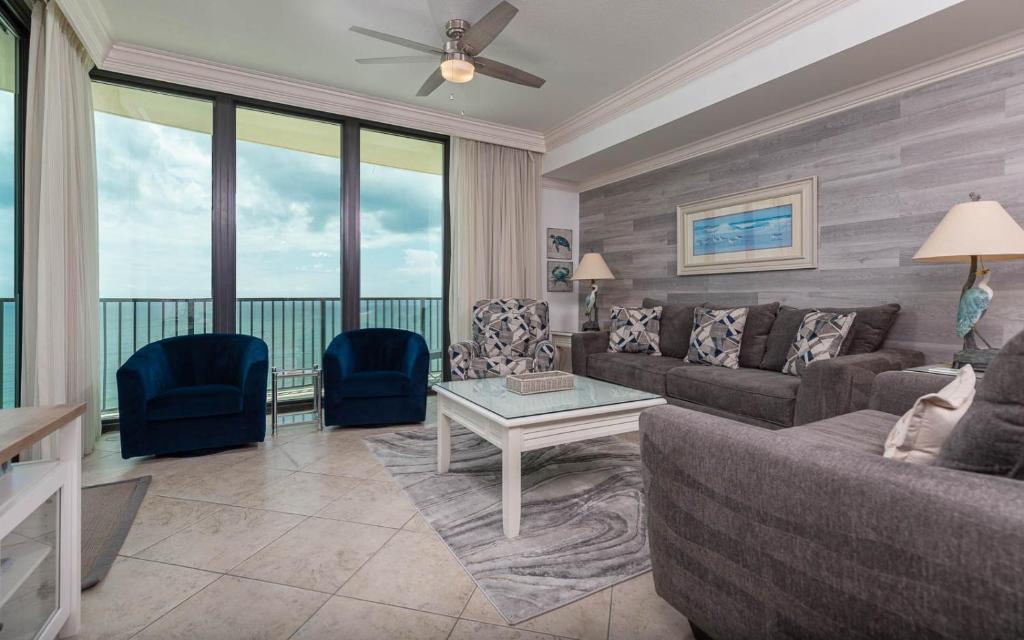 a living room with a couch and a table at Phoenix IX 1105 condo in Orange Beach