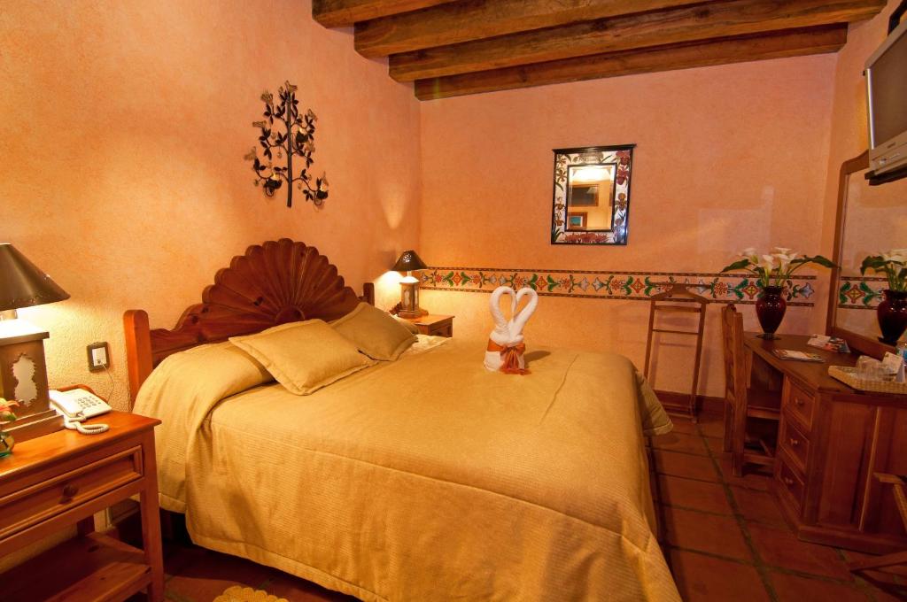 Postel nebo postele na pokoji v ubytování Hotel Pueblo Magico