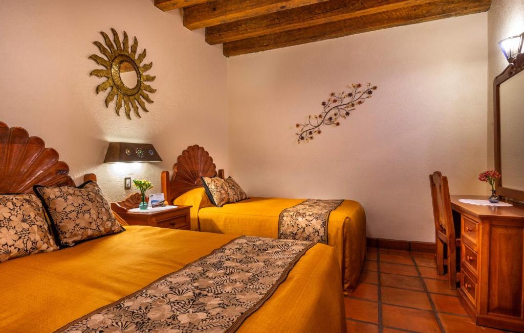 Postel nebo postele na pokoji v ubytování Hotel Pueblo Magico