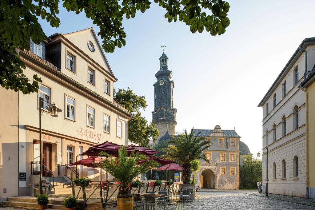 a city street with a clock tower in the background at Pension Kleine Residenz in Weimar