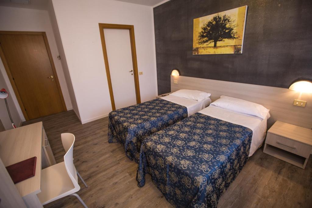 Postel nebo postele na pokoji v ubytování Hotel Rossi