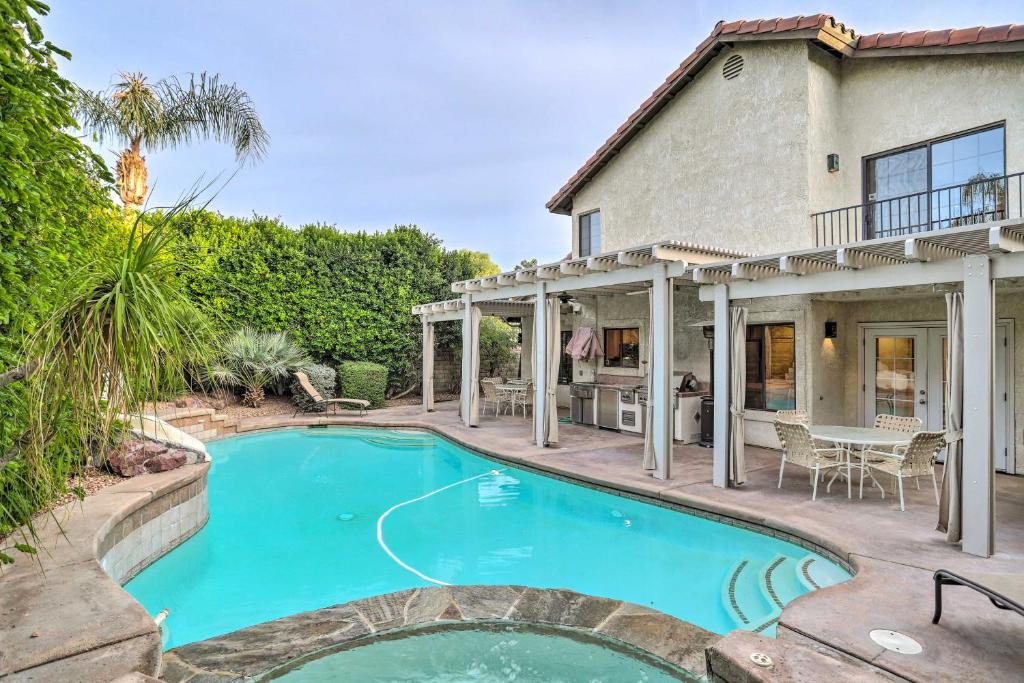 a swimming pool in front of a house at Luxury Living in La Quinta Home with Heated Pool! in La Quinta
