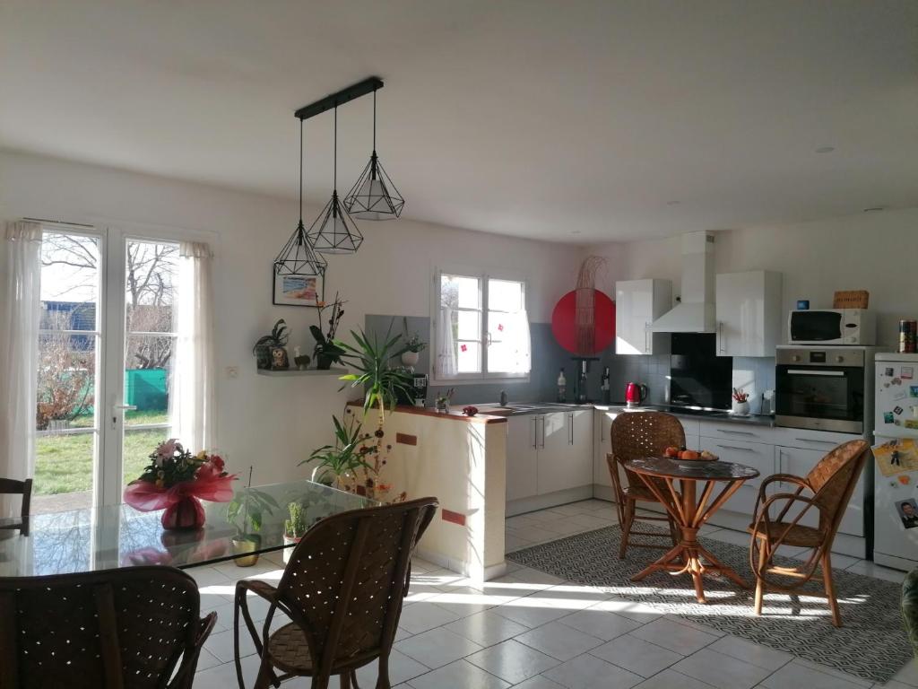 een keuken met een tafel en stoelen in een kamer bij Chambre au coeur de la Sologne in Romorantin