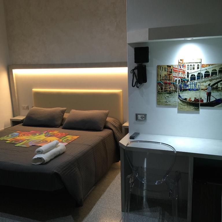 Postel nebo postele na pokoji v ubytování Hotel Ragno D'Oro