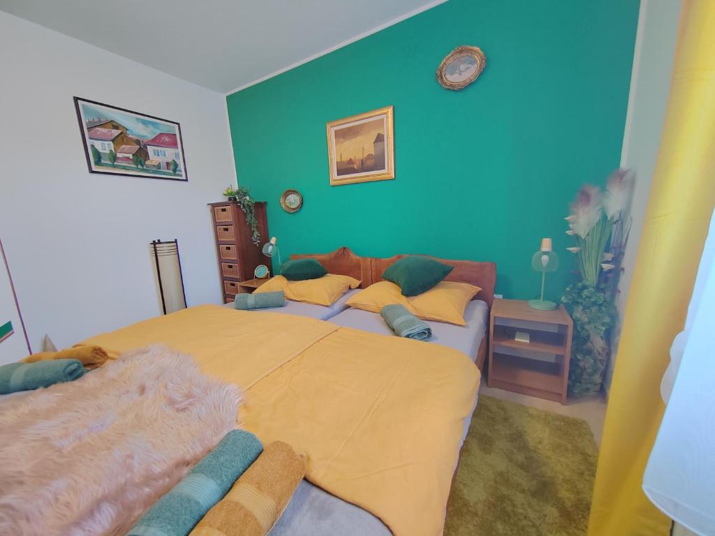 sypialnia z dużym łóżkiem i niebieską ścianą w obiekcie ARKI, KUĆA ZA ODMOR w mieście Karanac