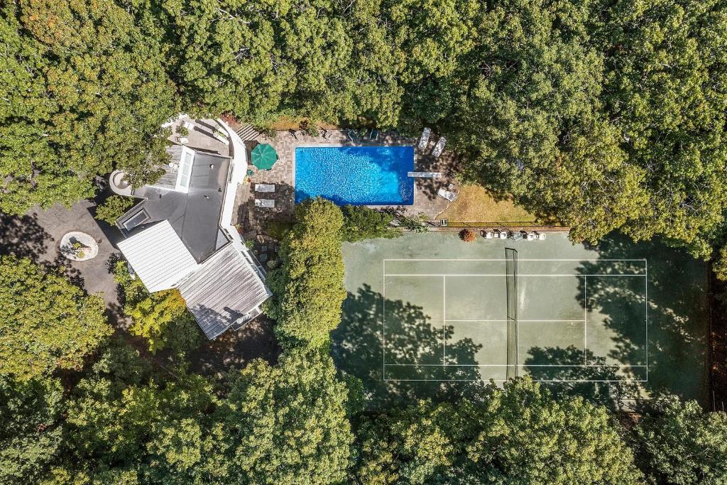 an overhead view of a tennis court in a forest at Rosemorran Retreat in Sag Harbor