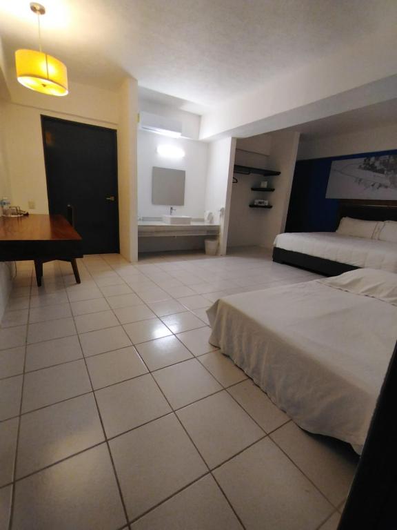 Postel nebo postele na pokoji v ubytování TRYP by Wyndham Chetumal