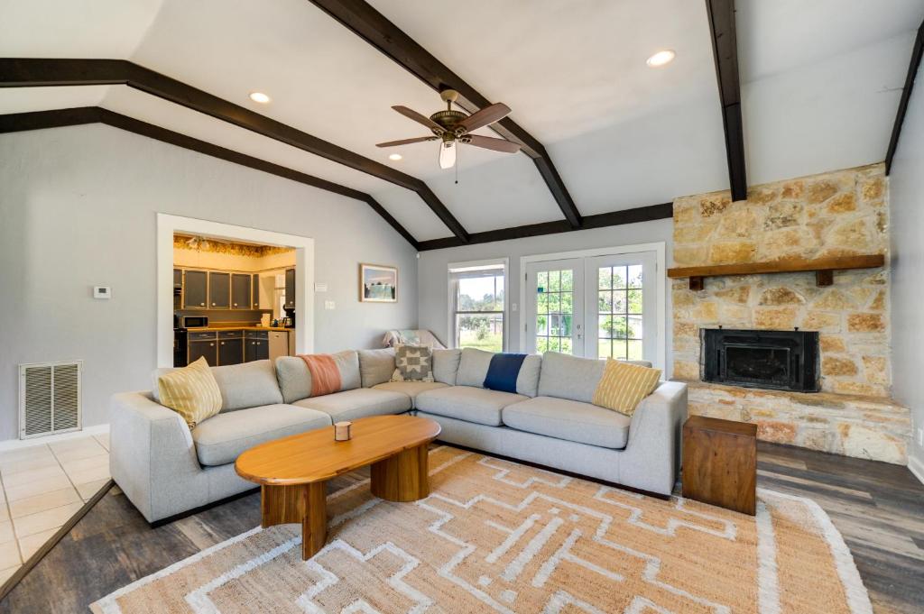 a living room with a couch and a fireplace at Rural Texas Vacation Rental with Fireplace in Dripping Springs