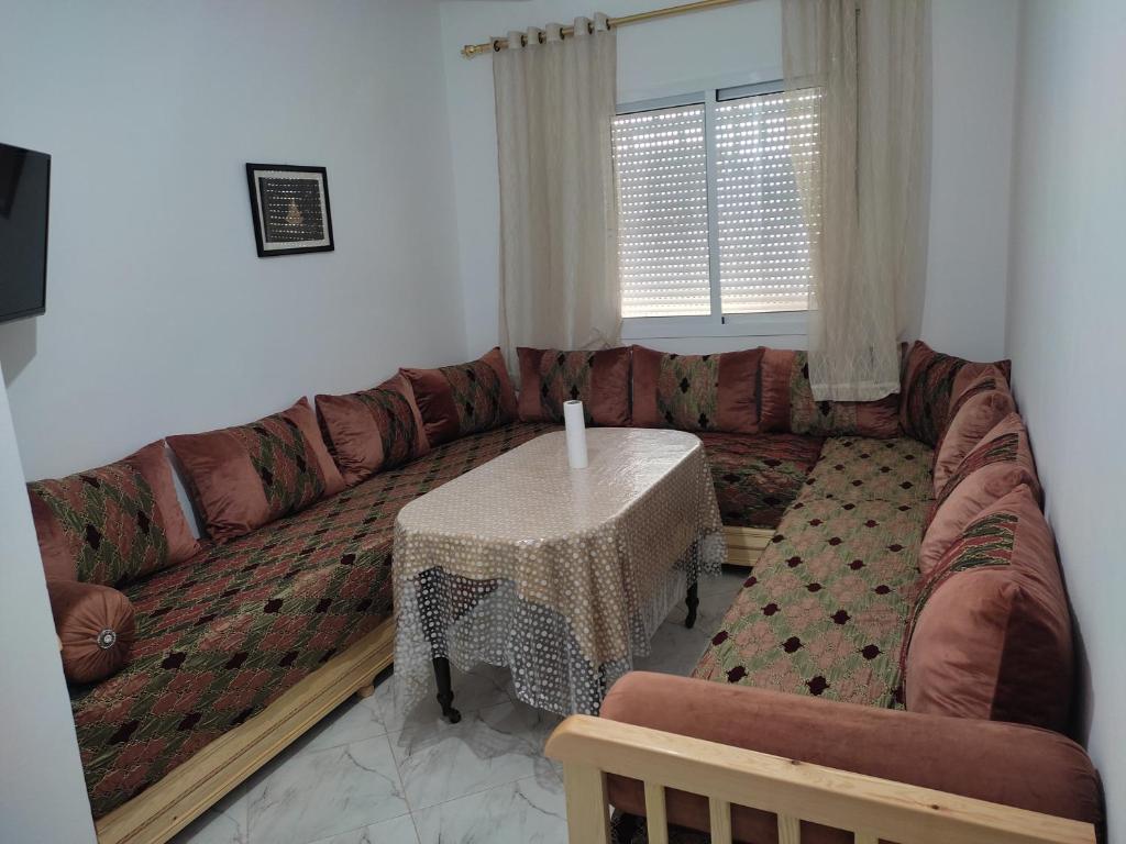 a living room with a couch and a table at Peaceful Apartment in Al Hoceïma