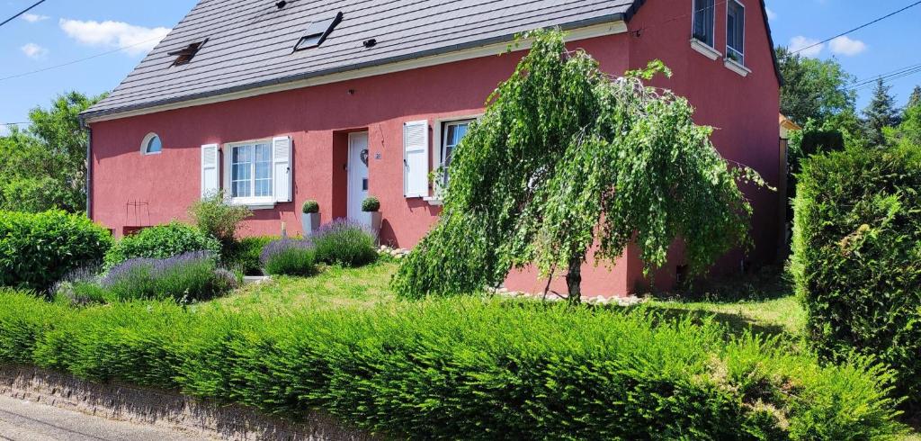 a red house with a tree in front of it at Au phil de la nath'ure 