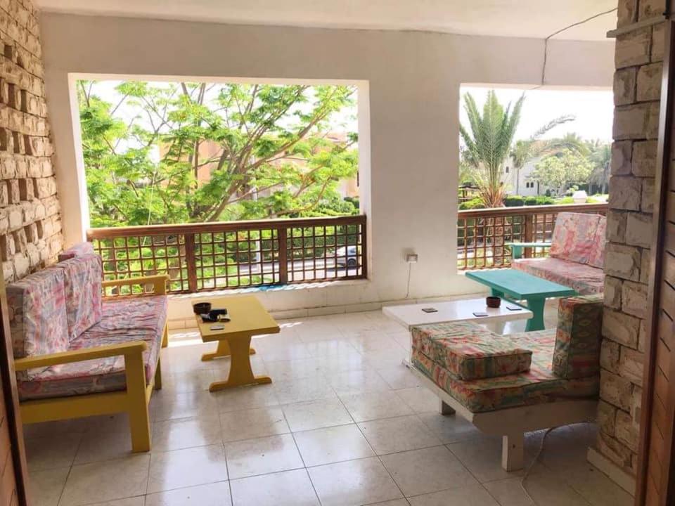 a living room with chairs and a table and a balcony at Beit Rumi in El Alamein