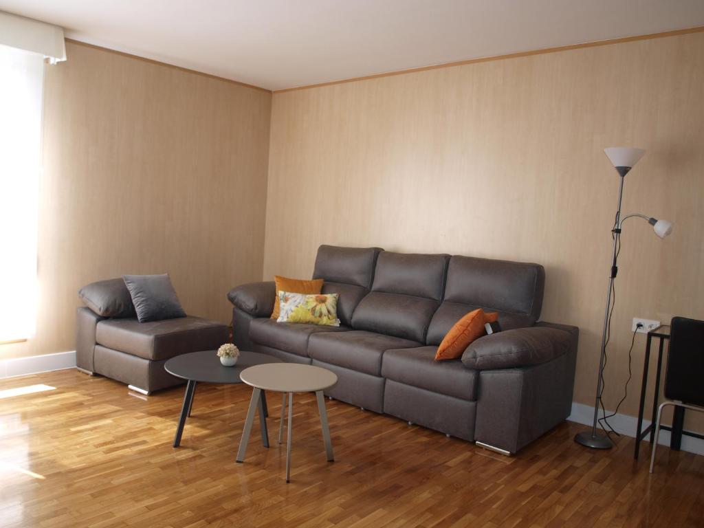 a living room with a couch and a table at Apartamento Sadar in Pamplona