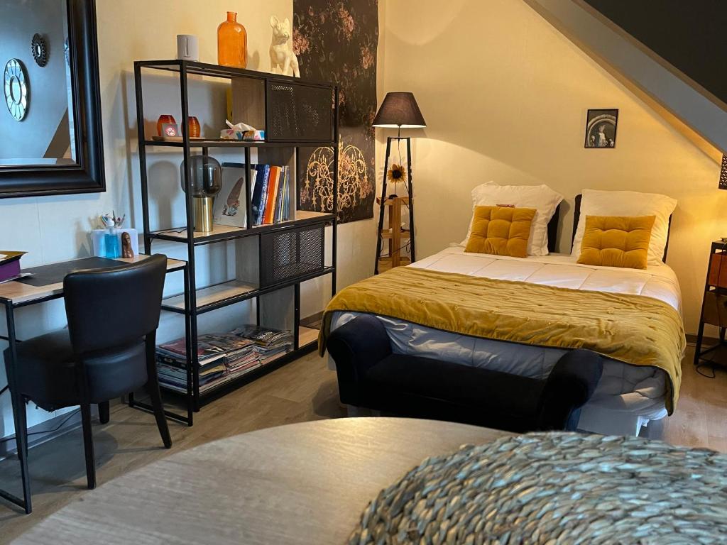 a bedroom with two beds and a desk and a chair at Studio VITRÉ CENTRE in Vitré