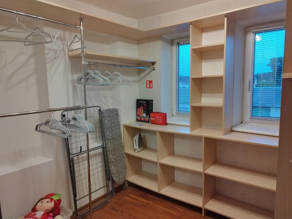 a walk in closet with shelves and a window at Spacious & Cozy Apartment with Forest View in Zapyškis