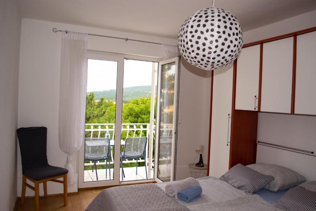 a bedroom with a bed and a large window at Apartment SeaShell in Jadranovo