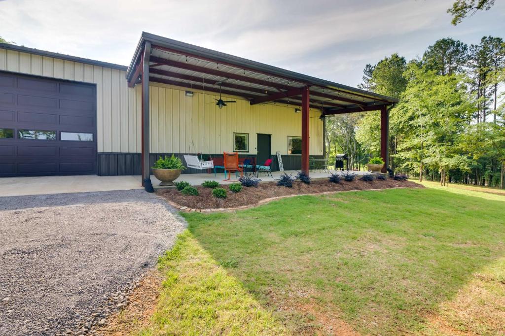 a garage with awning next to a yard at Charming Starkville Vacation Rental about 5 Mi to MSU! in Starkville