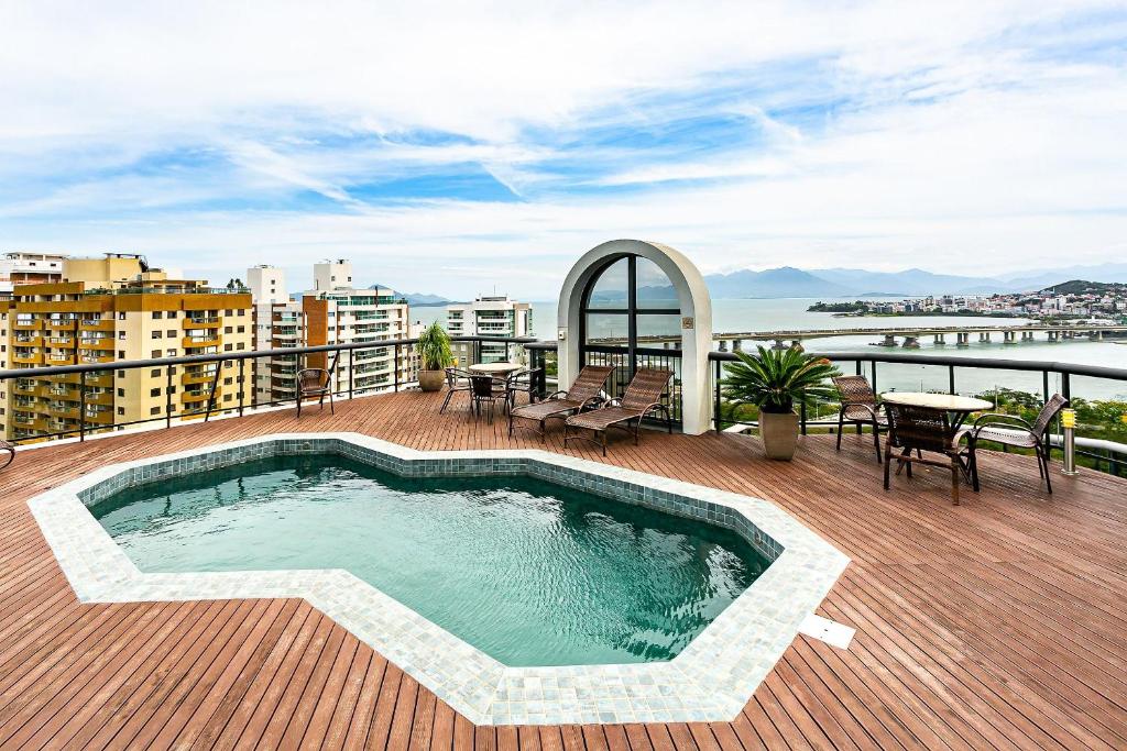 a swimming pool on the deck of a building at WI-FI 500MB | Pool | Balcony with Sea View #CA46 in Florianópolis