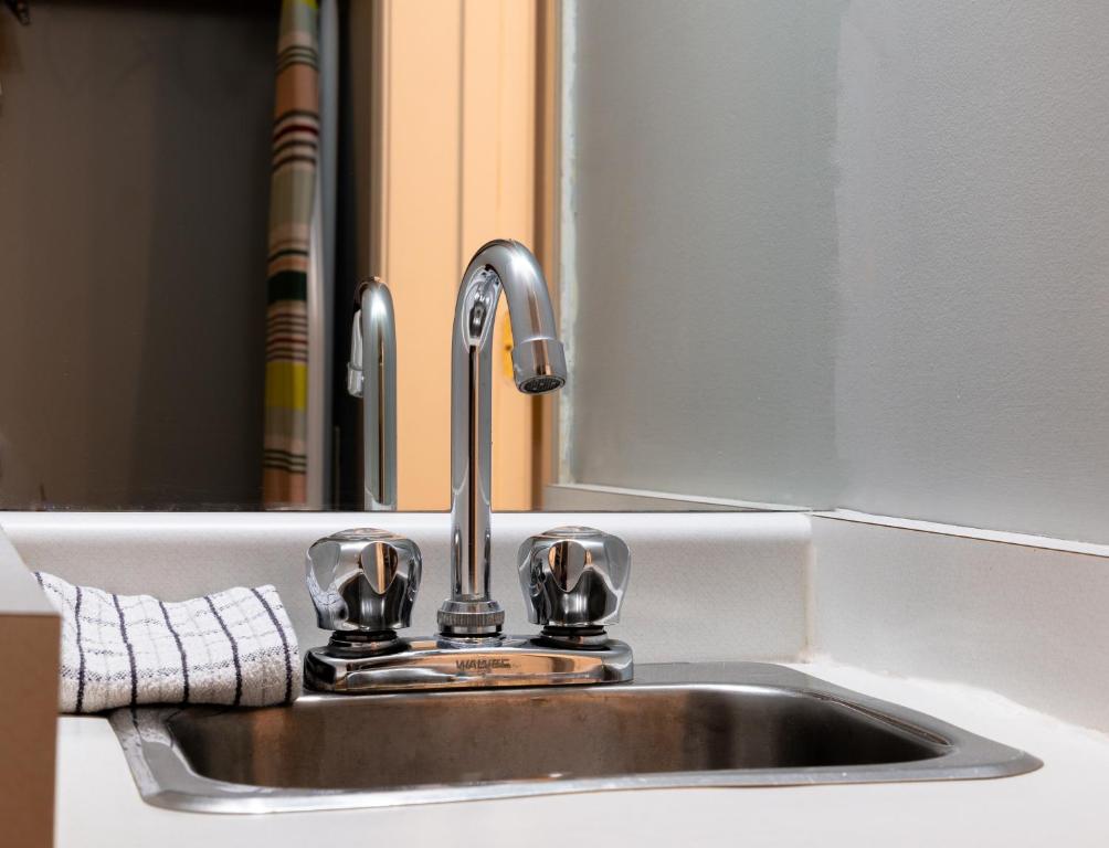 a sink with a faucet in a kitchen at Mountain View Inn in Canmore