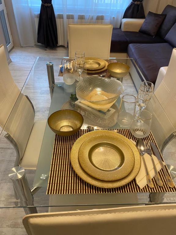 szklany stół ze złotymi płytkami w obiekcie Iva Luxury Apartament w mieście Ruse
