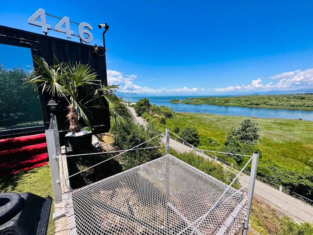 a gate leading to a view of a river at 446 Tiny House Shirokë in Široka