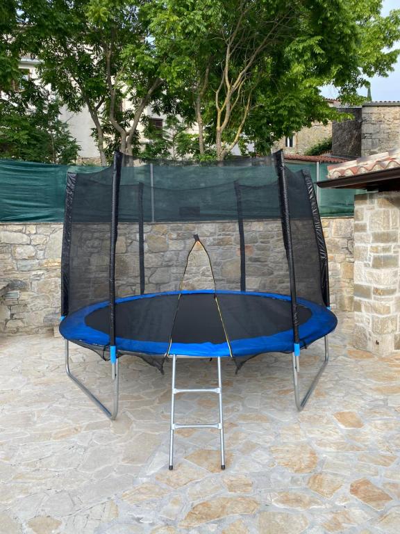 a trampoline with a blue top on a patio at Casa di nonno Giovanni in Buzet