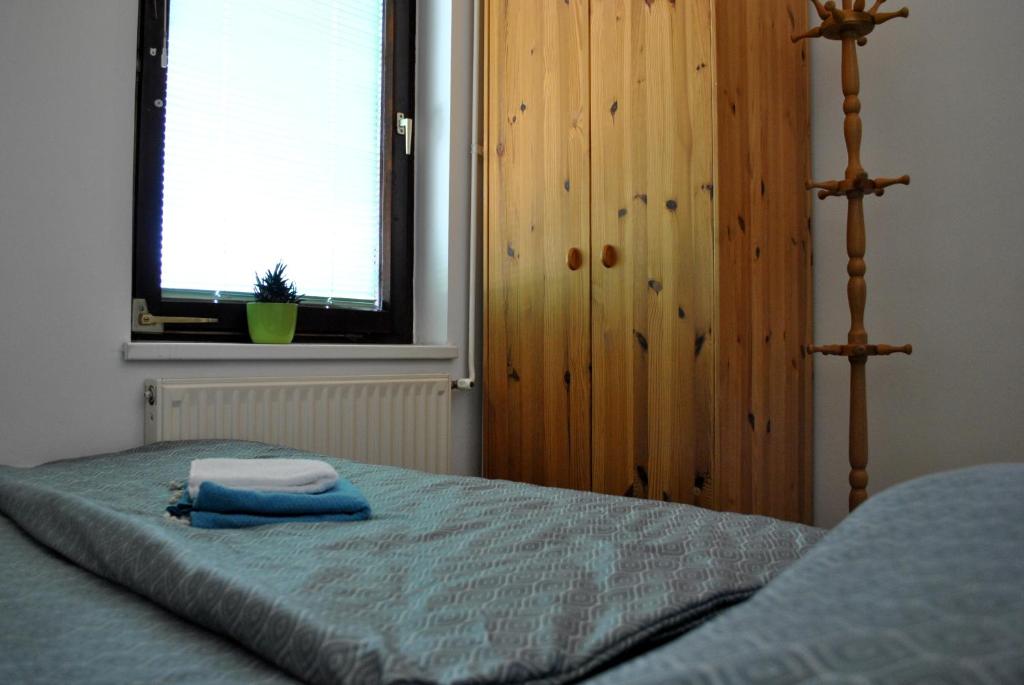 a bedroom with a bed with two towels on it at Riverside Village Apartment in Bohinj