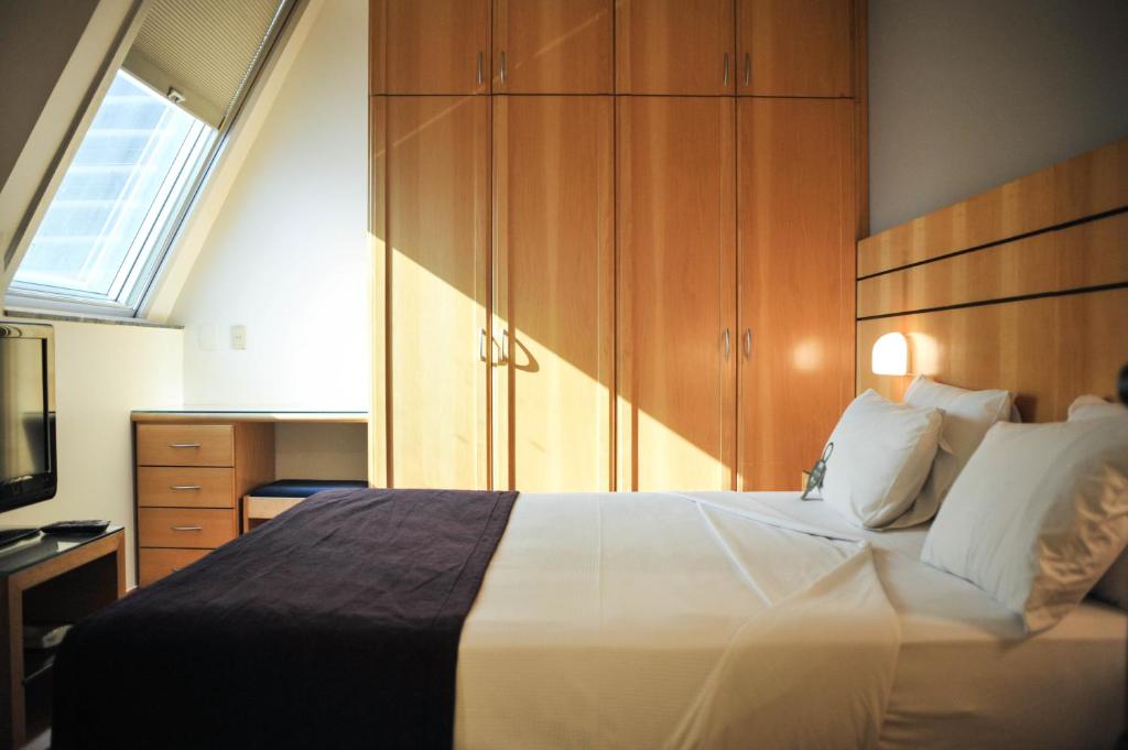 Cama ou camas em um quarto em San Diego Suítes Lourdes - OFICIAL