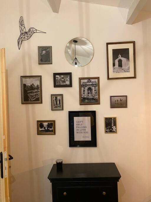 a room with a table and pictures on the wall at Charmante maison avec extérieur à deux pas des remparts in Aigues-Mortes
