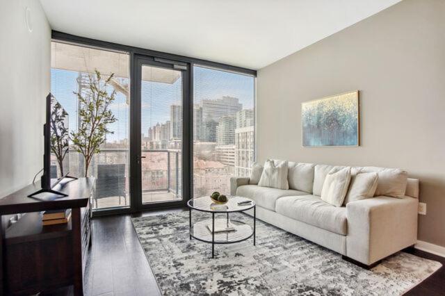 a living room with a couch and a large window at Piedmont Park 2 bdrm in Atlanta