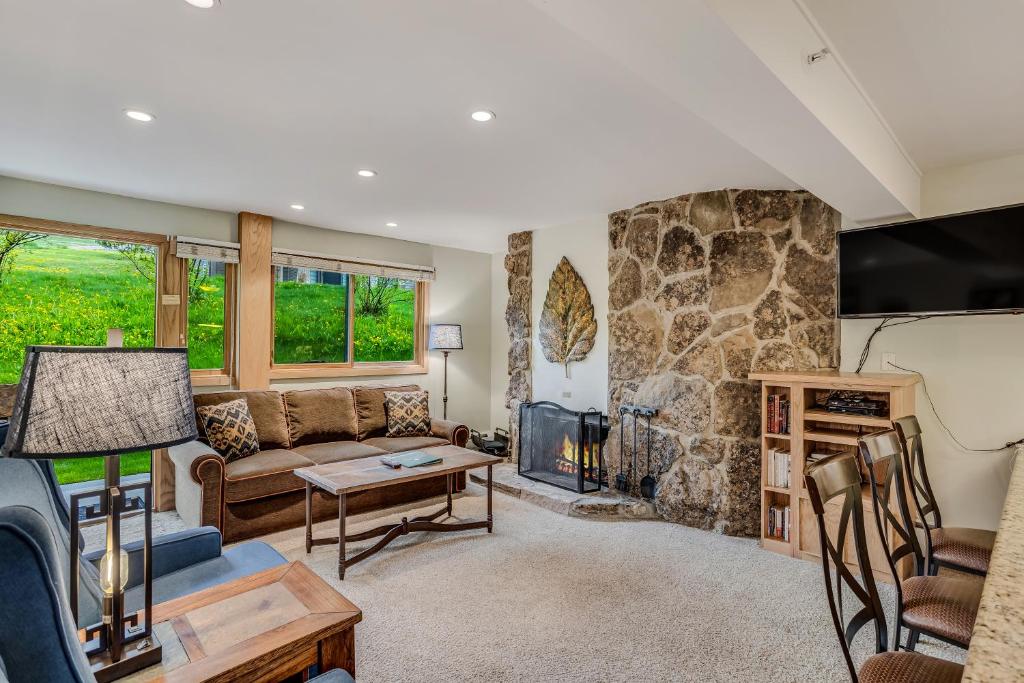 a living room with a couch and a fireplace at Laurelwood Condominiums 405 in Snowmass Village