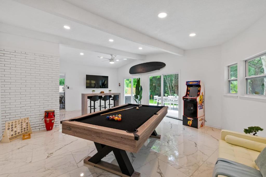 a living room with a pool table in it at Cabana Isla- Hot Tub- Boat RV- Mins to DT & Beach in St. Augustine