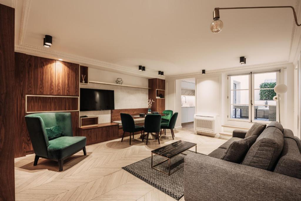 a living room with a couch and chairs and a table at HIGHSTAY - Luxury Serviced Apartments - Place Vendôme in Paris