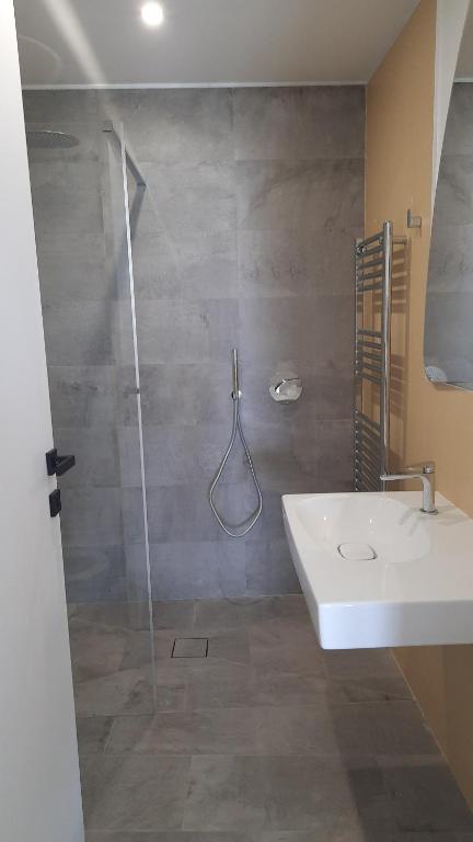 a bathroom with a shower with a sink and a shower at Locanda Göghin in Pieve Ligure