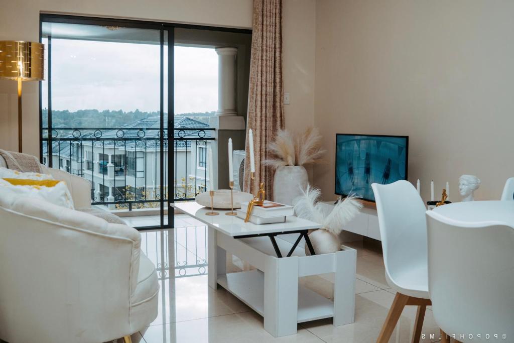 sala de estar con mesa y sillas y balcón en Sunset Gold-2 Bedrooms Apartment en Fourways